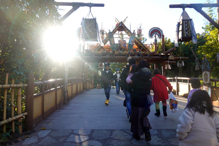 People walking on the bridge in the amusement park in the evening.の写真素材