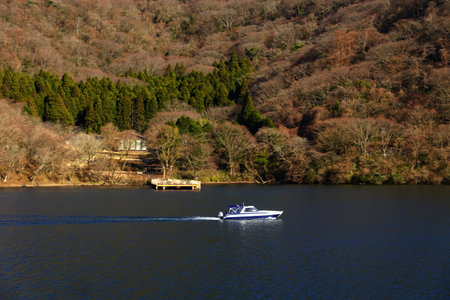 A small motorboat on the lake in the forest, Japan.