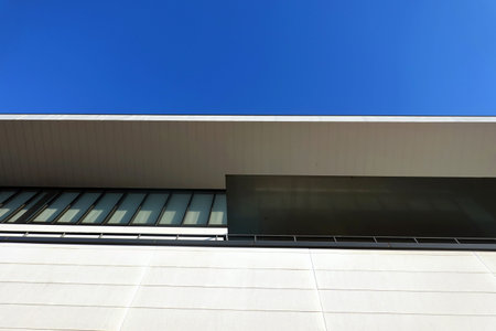 Exterior of modern office building with blue sky, closeup of photo