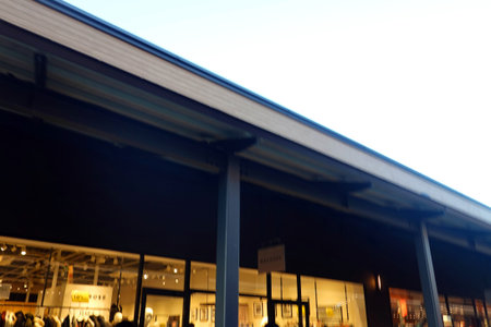 A low angle shot of a shop building at night with a blurred background