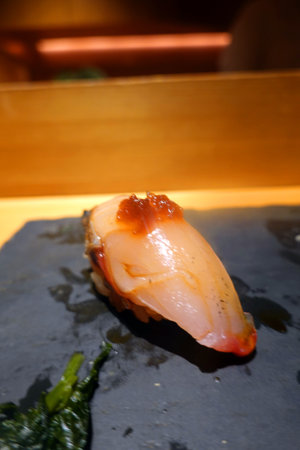 Japanese food, nigiri sushi on a black plate in a restaurantの写真素材