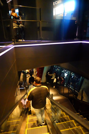 people walking down the escalators in Shanghai, China