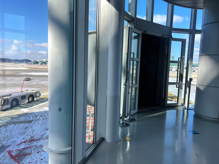 Entrance to the airport with an open door and a view of the plane