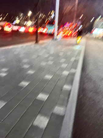 Blurred view of a city street at night. Intentional motion blurの写真素材