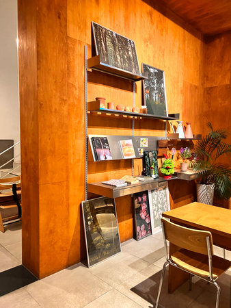 Interior of a modern coffee shop with wooden tables and chairs.のeditorial素材