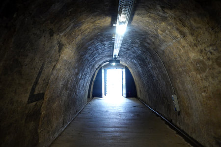 Underground tunnel with light coming from the end of a tunnel.