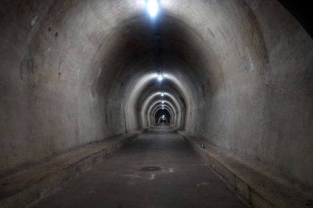 Underground tunnel with light at the end of the tunnel, perspective viewの写真素材