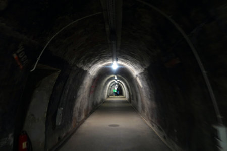 Tunnel in the dark, with light and shadow from insideの写真素材