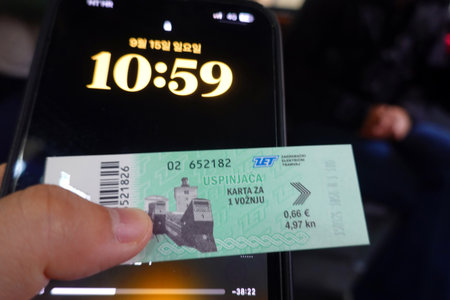 A man using a smartphone to pay for a taxi in Kuala Lumpur.の写真素材
