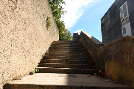 Staircase to the top of the stone wall. The stairs are made of concrete.