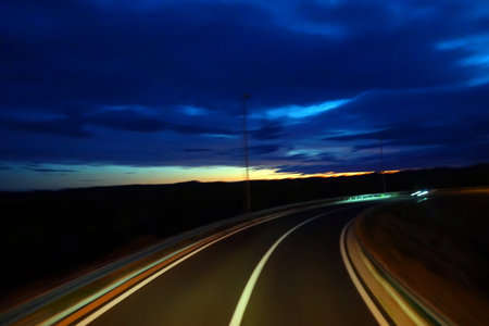 car on the road at night, motion blur, closeup of photo