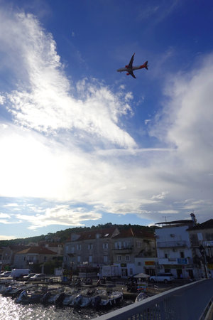 View of the port of Rovinj in Croatia with a plane taking off