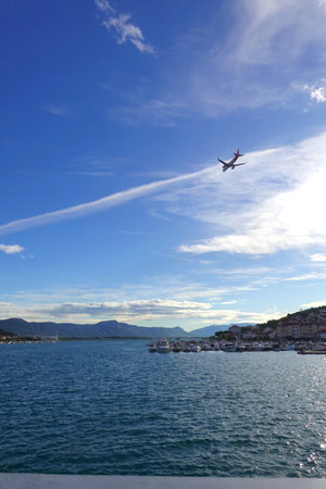 Airplane flying over the Adriatic Sea in Dubrovnik, Croatiaの写真素材