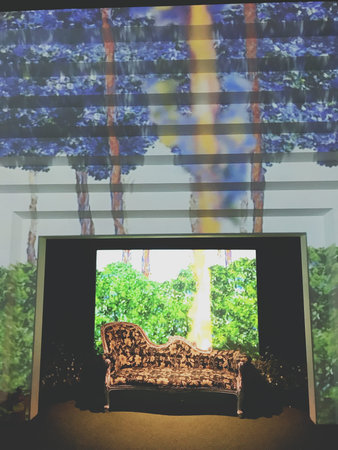 Wicker chair in front of a window with a view of nature