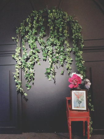 Wedding arch with ivy and flowers on the wall.の写真素材