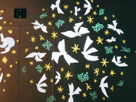 Abstract pattern of white and yellow paper birds on a black background.の写真素材