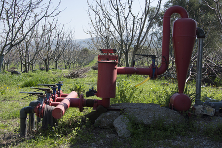 Materials ; Drip irrigation pipes, valves, blind plug, fertilizer tank, filters, reduction T and elbow. Trees are used for irrigationの写真素材