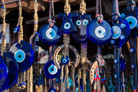 Evil eye bead souvenirs.broken glass is melted and shaped. In culture and religious belief, the figure of the eye is regarded as a powerful amulet protecting evil. It is a powerful talisman in Turkish culture.の写真素材