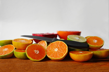 citrus fruit frame. Free space for text. fruits sliced cut with knife. heap of fresh organic fruitsの写真素材