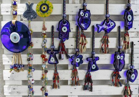 Evil eye bead souvenirs.broken glass is melted and shaped. In culture and religious belief, the figure of the eye is regarded as a powerful amulet protecting evil. It is a powerful talisman in Turkish culture.の写真素材