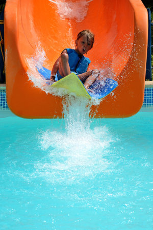 boy on a slide of waterの写真素材