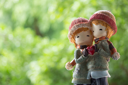 Two Dolls Winter Suit hug and holding Love Heartの写真素材