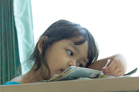Illness little asian kids sit on a chair in hospital, saline intravenous IV on handの写真素材