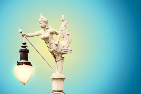 Sculptures of woman and bird is a lantern  with gradient backgroundのeditorial素材