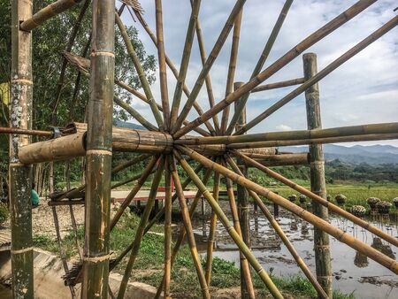 Water wheel is an essential agricultural tool that helps locals deliver water from the lower rivers or streams to the higher rice paddies for irrigationの写真素材