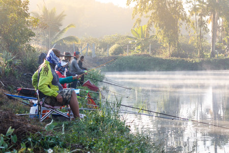 FANG,CHIANG MAI/THAILAND - DECEMBER 22,2018: Fishermen catch fish at the lake in the morning with...