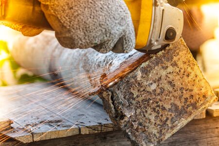 Sparks flying over the working during metal grindingの写真素材