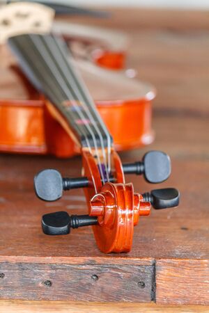 Close up of a violin shallow deep of field on wood backgroundの写真素材