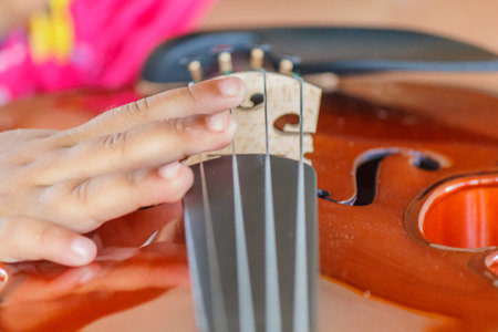 Hand of a kids with a violin shallow deep of field