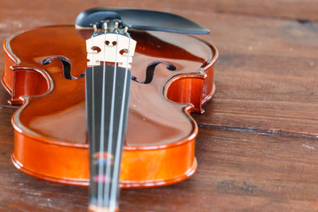 Close up of a violin shallow deep of field on wood background