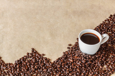 White cup of coffee and coffee grains surrounded