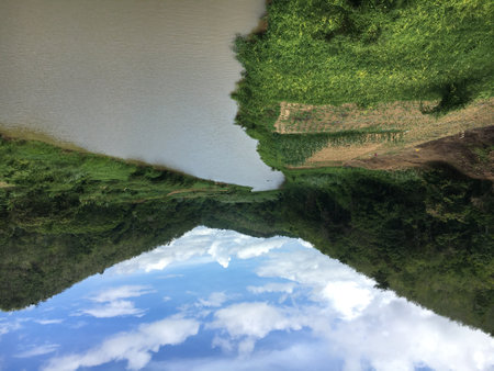 Reflection of the sky and clouds in the lake, Thailand.の写真素材