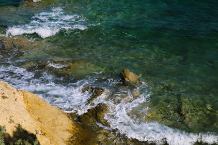 Sea surf on stones top view