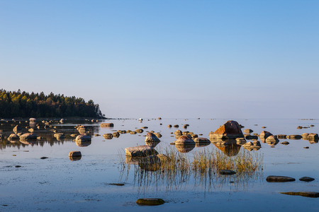 Beautiful stones in the bay of Baltic sea at a sunsetの写真素材