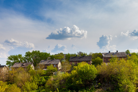 Belgian houses on the green slope and bright sky in Lisichansk, Ukraineの写真素材