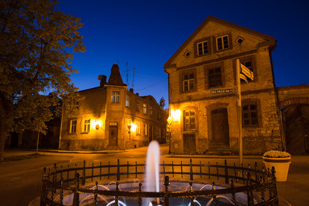Summer night in old town of Cesis, Latvia. Fountaine and old stoned houses.の写真素材