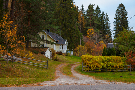 Traditional Northern European house surrounded by fall foliage. Estonia.の写真素材