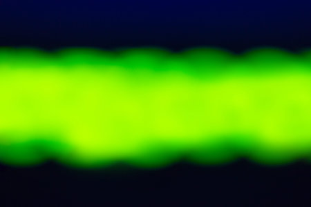 Green neon strip on a black background, blurの写真素材