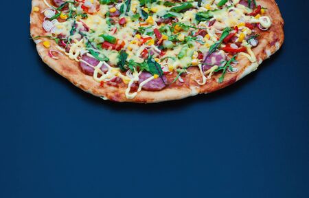 Homemade hot pizza. Top view with copy space on dark stone table.の写真素材