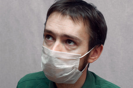 sick man in a medical mask. sad eyes close up. portrait