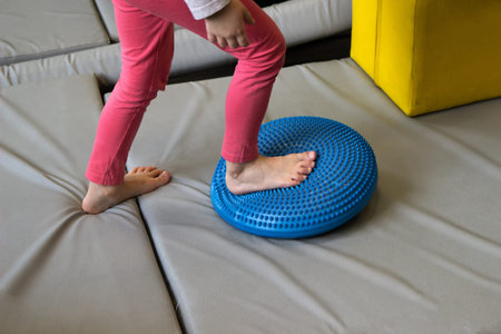 Girl made exercises for sensory integration dysfunction. Sensory processing disorder.の写真素材