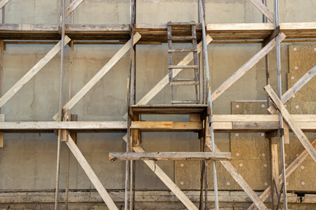 wooden scaffolding during the construction of a large house or cottage outside the cityの写真素材