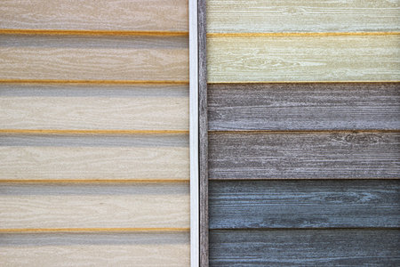 Siding made in the texture of wood close-up. variety of samples on display