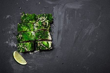 Sushi rolls with seafood and Chuka salad. Green sushi. Top view. Free space for your text.の写真素材