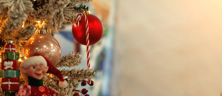 Decorated Christmas tree close-up background with copy space. Red ball illuminated garland with...