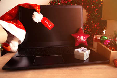 christmas shopping online with laptop, x-mas sale at home in holiday decor, close upの写真素材